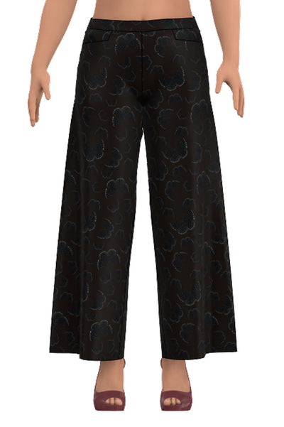 Vida trikåbyxor med resår i midjan, fickor och längd till ankeln i mörkbrunt tyg som har svarta fjärilar i vita prickar från märket Esther & Inez